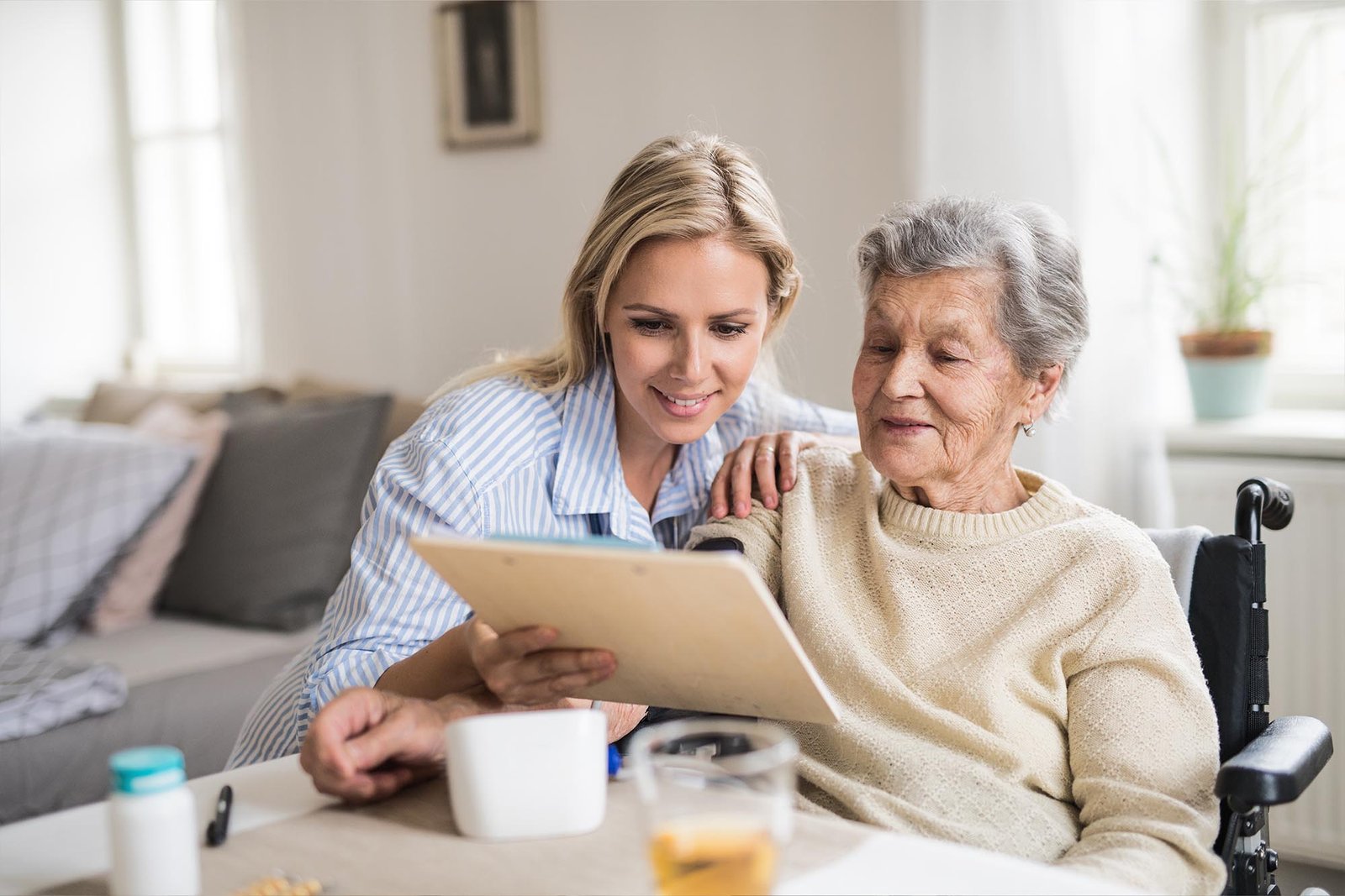 Senior man playing chess with his caregiver.