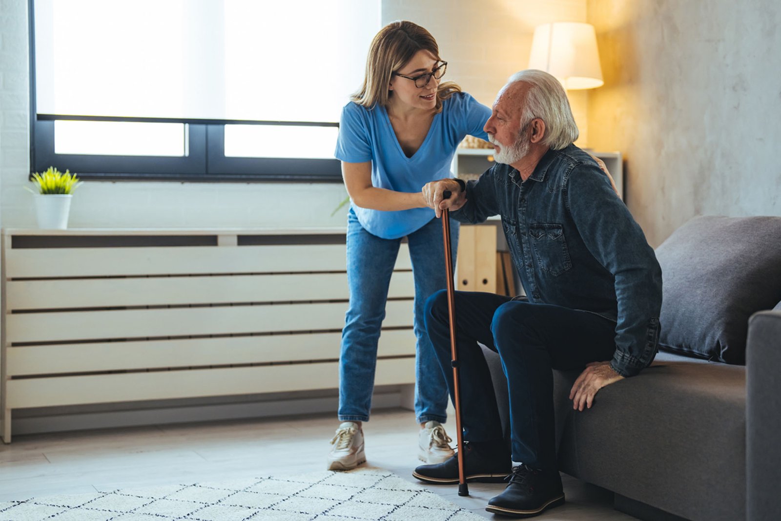 Senior man playing chess with his caregiver.